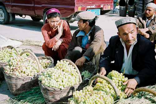 Grape vendor at bazaar in Uyghur, China